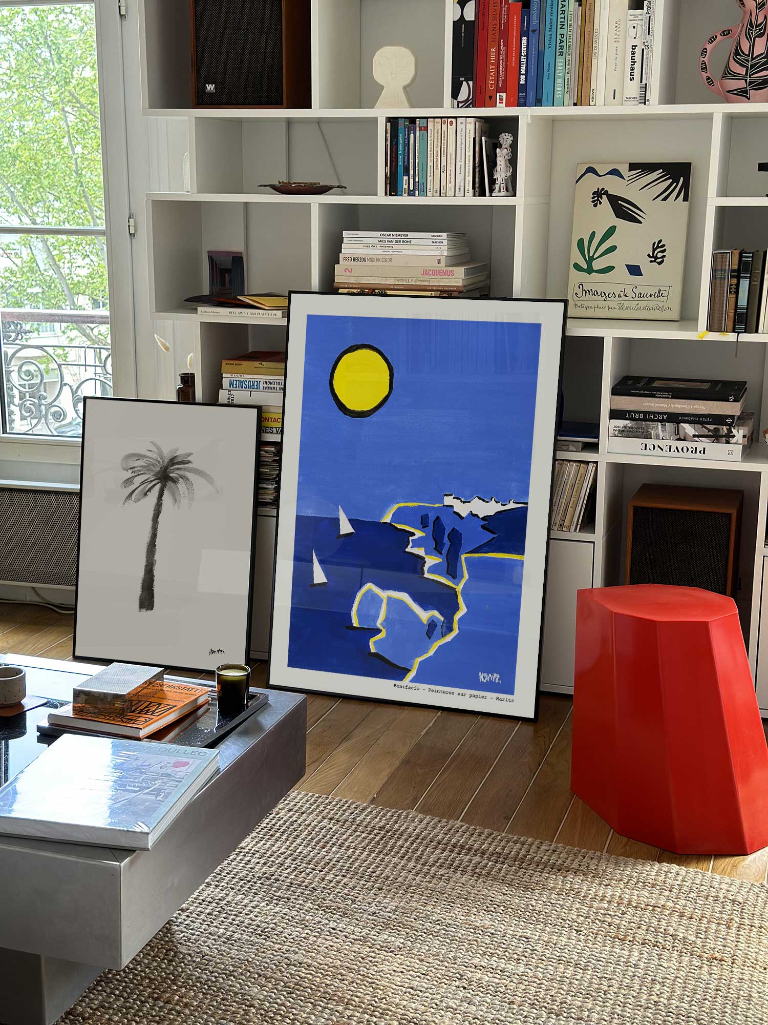 Affiche Bonifacio de Haritz grand format dans un salon parisien design devant une bibliothèque blanche avec livres d'art.
