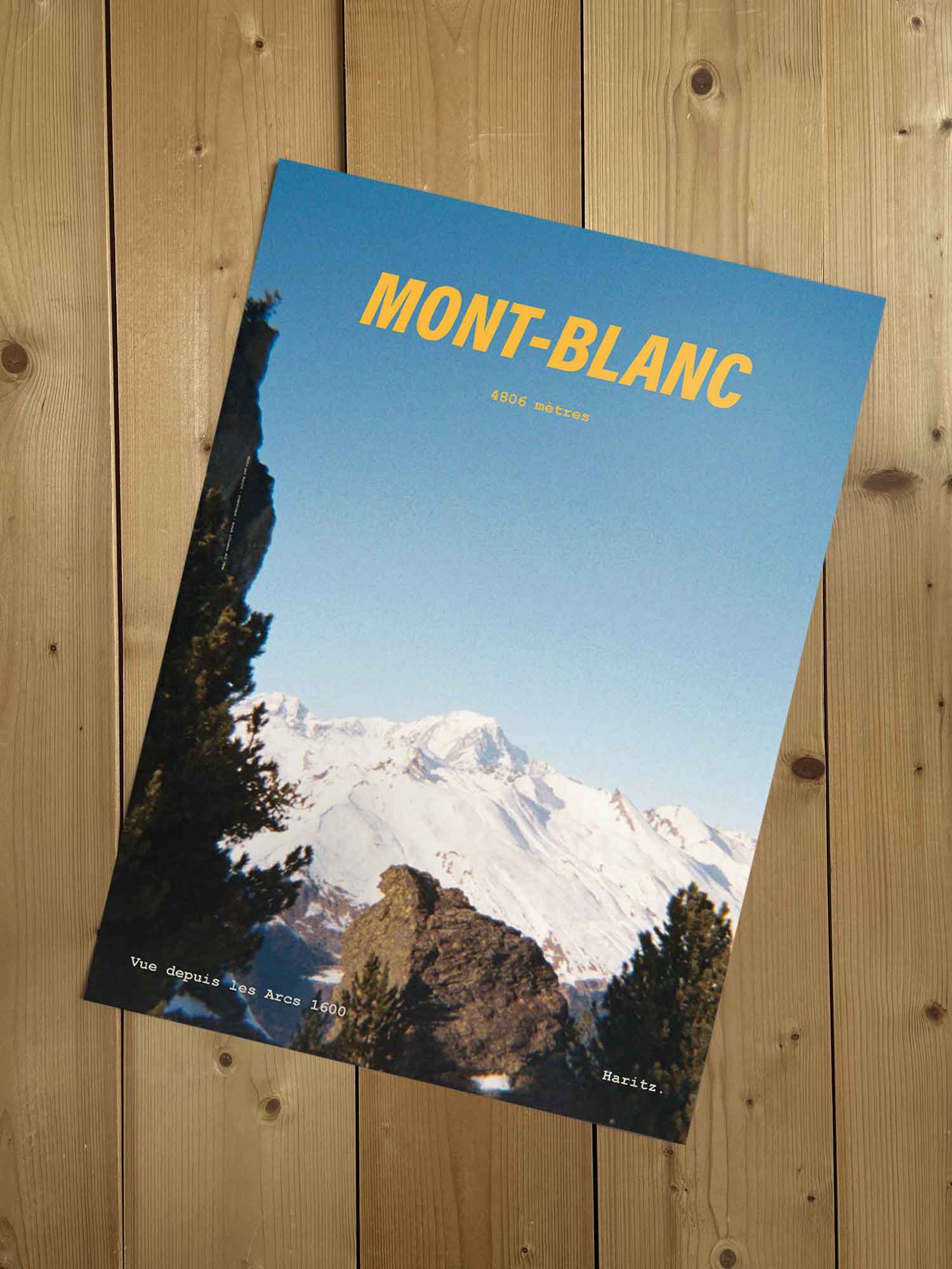 Affiche Mont-Blanc vintage sans cadre posée sur parquet bois — sommet à 4806 mètres vu depuis les Arcs 1600, photographie argentique Haritz