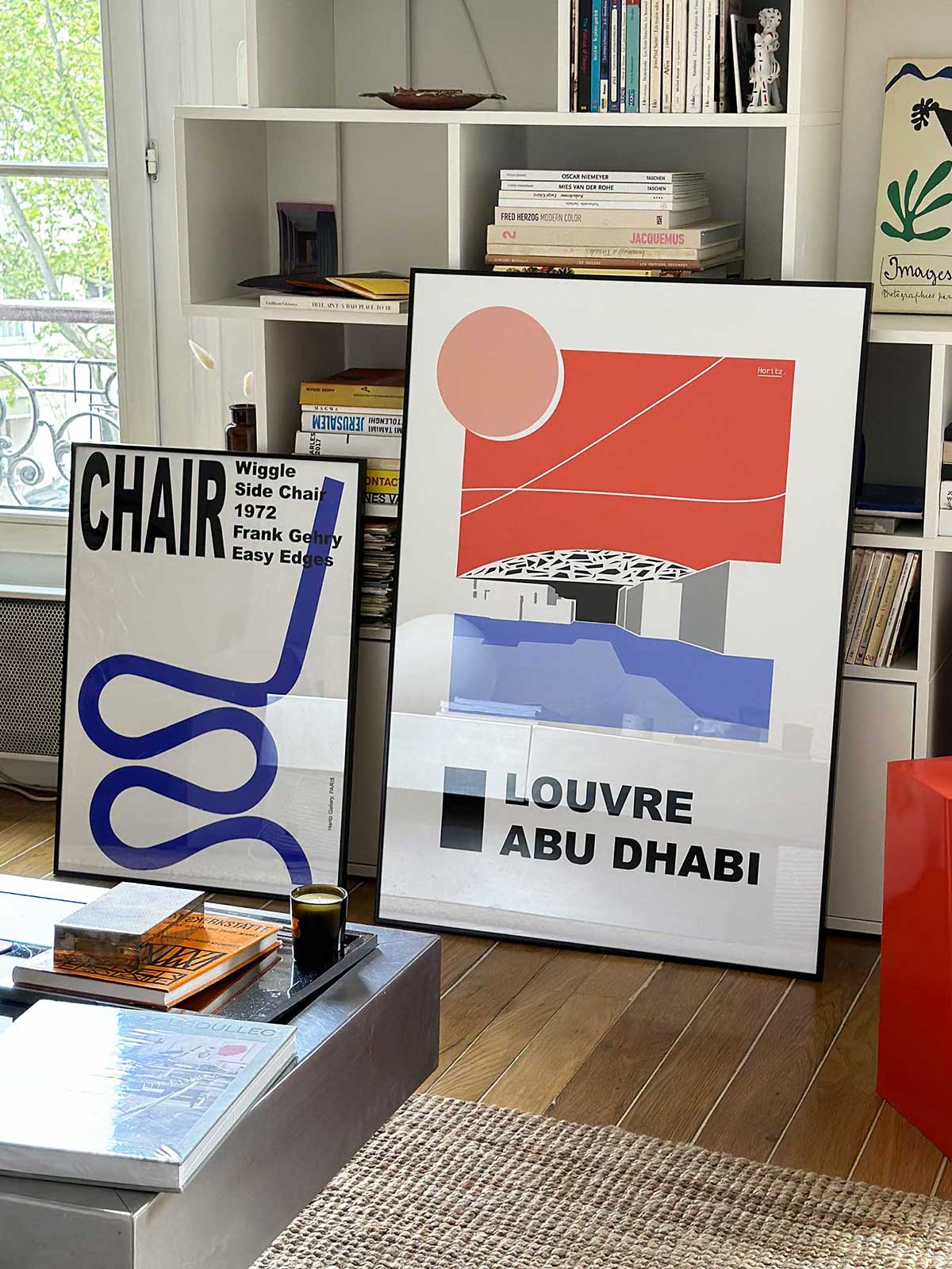 Affiches Haritz Louvre Abu Dhabi exposée dans un appartement parisien — décoration intérieure contemporaine avec livres d'art et design